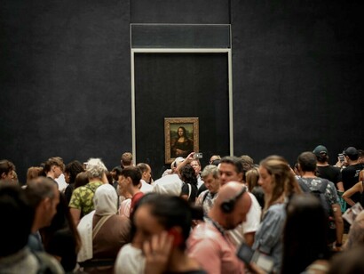 Visitors at the Louvre Museum in Paris admire the Mona Lisa painting, France