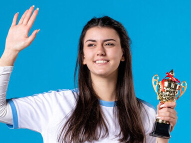 Woman athlete receiving a trophy at a public awards ceremony, highlighting community recognition and appreciation