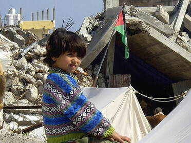 Palestinians assess the damage after an Israeli airstrike hit the El-Remal area in Gaza City on October 9, 2023