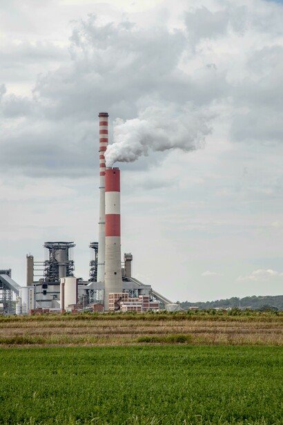 Industrial emissions from a power plant highlighting accelerated climate change