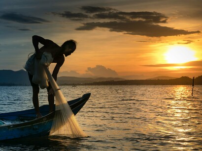 A solitary fisherman against the fading evening light, symbolising the daily struggle that gradually replaced a life once filled with music and performance