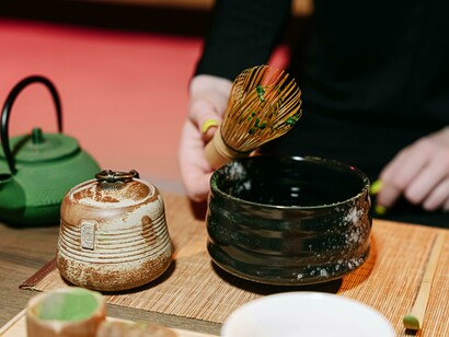A person preparing matcha during a traditional tea ceremony