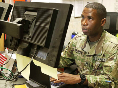 U.S. Army Staff Sgt. Thomas Browne, originally from Liberia, serves as the billeting NCO at Taji Military Complex in Iraq after surviving civil war and refugee camps in his childhood before later becoming an American citizen