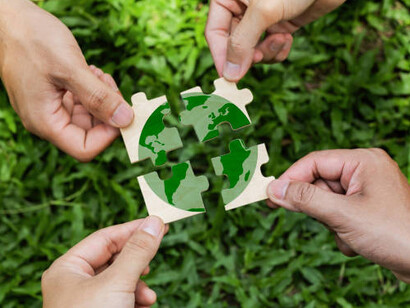 Achieving environmental sustainability requires joint efforts from businesses, corporations, and communities—symbolized by the shared responsibility of holding the world in their hands