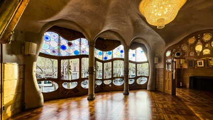 Barcelona, Spain, the interior of Casa Batlló featuring a decorative ceiling and large windows, showcasing Antoni Gaudí’s distinctive design style