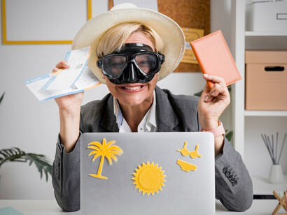 Middle-aged businesswoman at her desk, daydreaming about her summer vacation