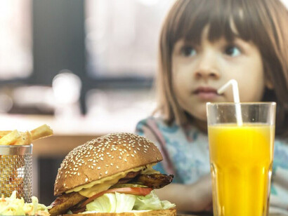 A child eating sugary and processed fast food, illustrating the impact of junk food on kids’ diets
