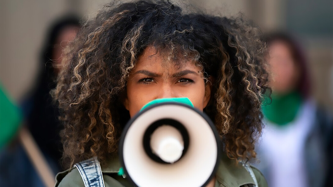 A woman protesting outdoors symbolizes the shift toward grassroots activism