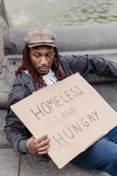 Man with a sign 'homeless and hungry'