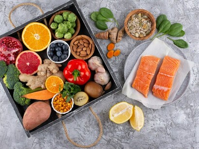 A top-down view of immunity-boosting foods, including vibrant vegetables, fish, and functional ingredients such as probiotic-rich and brain-enhancing options