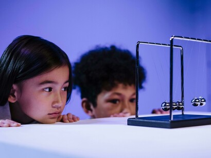 Estudiantes observando el péndulo de Newton