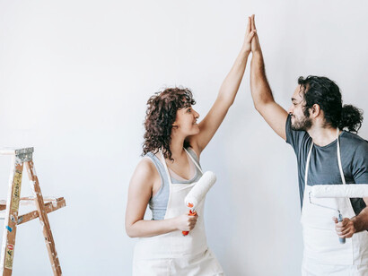Posing in front of freshly primed walls, they share a moment of anticipation, envisioning the cozy evenings and lively gatherings that will soon fill their home