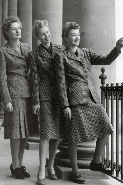 Women showcasing 1940s utility fashion in stylish, practical outfits