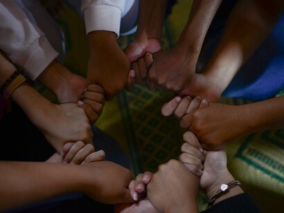 Hands of different races and ages banding together as a sign of unity which is a rare sight in this world