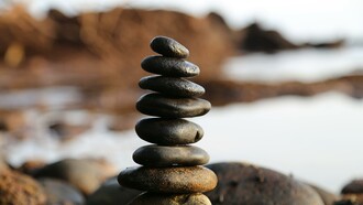Pile of rocks next to a lake 