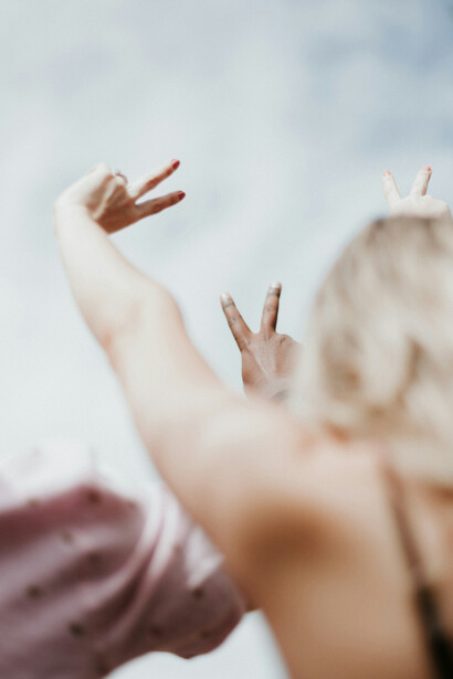 Diverse people making the v-sign to represent peace