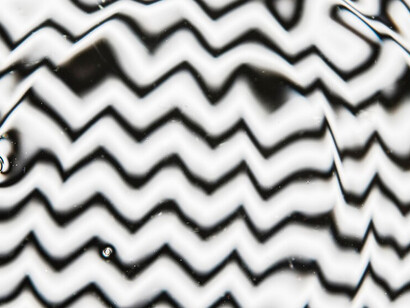 Water ripples on a black and white pool surface