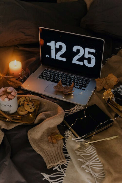 Enjoying the simple pleasures of life, on an autumn evening, watching movies on computer while sipping on a comforting glass of milk with cookies