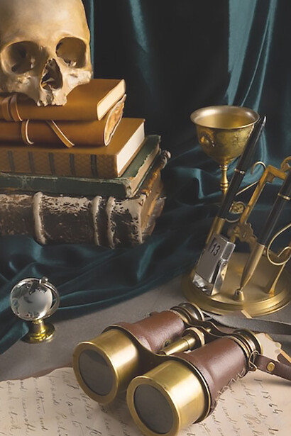 A carefully curated display showcases pirate artifacts on a vintage table, including a weathered map, battle-ready gear, and a pair of antique binoculars