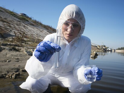 Environmental scientist collecting water samples to test for petroleum contamination