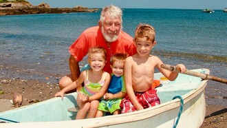 Farfar posing with his grandchildren on his old rowboat