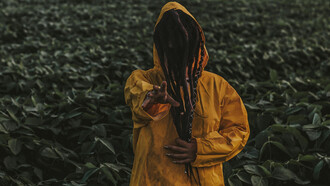 A man in yellow reaching for the viewer, reminiscent of a terrible King who wore the same color