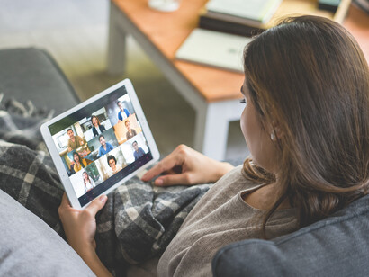 Woman exploring a streaming service on a tablet computer, searching for the perfect movie to watch