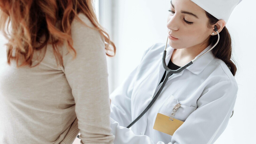 A doctor examining a patient who has an autoimmune disease