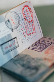 A collection of visas adorning the pages of a passport like colorful stamps from around the world