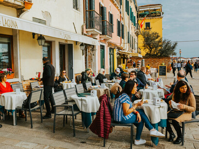 People enjoying a charming outdoor café in Venice, Italy