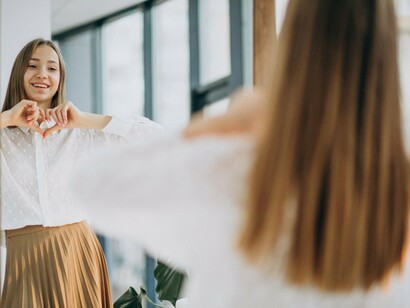 A woman looking at herself with renewed confidence, symbolising inner growth through self-belief and inner reassurance
