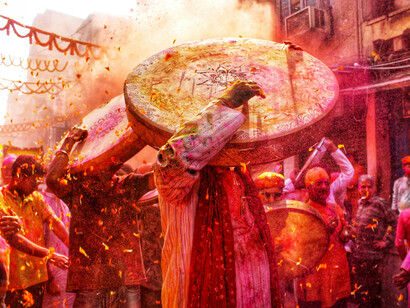 A burst of color marks the Holi parade in Kolkata, WB, India, as people throw vibrant powder in celebration