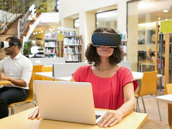 A woman immersed in AI-driven learning through a VR headset, expanding her skills as a polymathic thinker