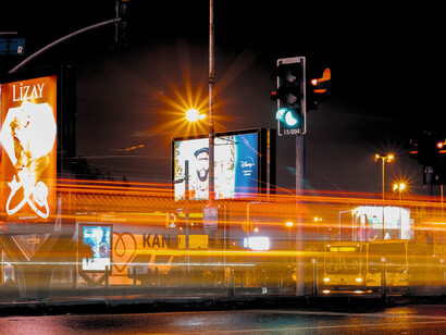 A city intersection illuminated by passing vehicles, reflecting the momentum and complexity of an AI race
