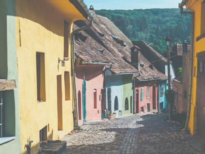 Homes painted in an array of vibrant colors grace the streets of Sighișoara, Romania, enhancing the medieval charm of this picturesque town