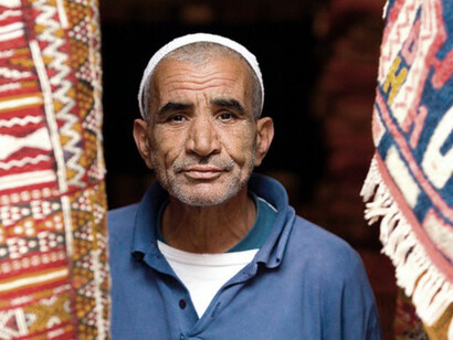 The intense gaze of the Moroccan man reflects the deep spiritual focus that Ramadan inspires, as he contemplates the sacredness of the month and its transformative power in his life