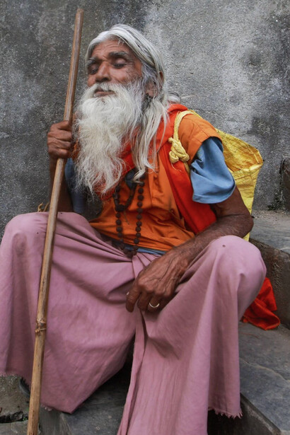 Elderly Monk with a Stick in Varanasi, India
