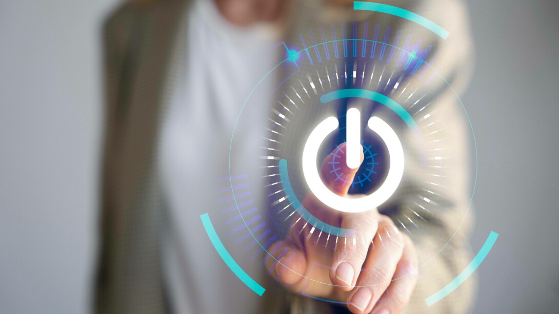 Persona che preme il pulsante di accensione