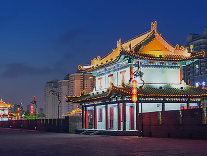 Explore the majestic beauty of the ancient Xian city wall illuminated against the night sky in China