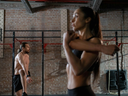 Two athletes engage in a HIIT workout featuring dynamic plyometric movements for full-body fitness