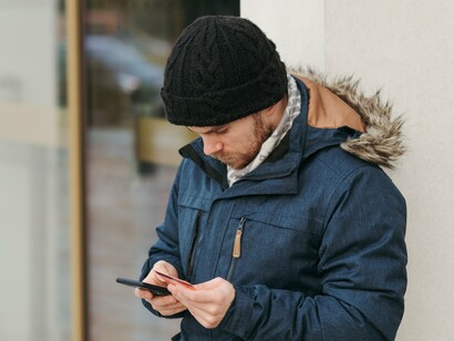 A person inputting his bank details onto his phone