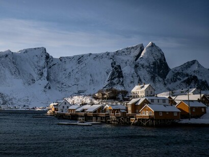 Snow-covered homes in Lofoten Islands, Norway, representing climate-responsive architecture designed to endure harsh Arctic conditions