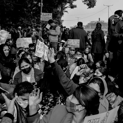 A black-and-white image of women holding banners during a protest, symbolising activism, awareness, and assembly