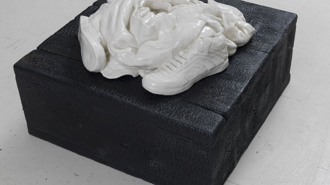 Reza Aramesh, Action 145: Friday April 25, 2003 at 07:55, 2015, Hand sculpted porcelain on charred wood plinth, 6 x 25 x 22 in. Photo by Brian Buckley