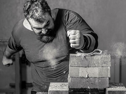 Man uses his fist to break bricks