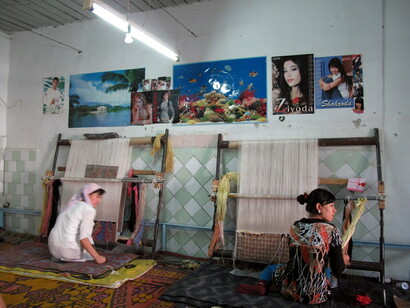 Women making silk carpets in factory in Uzbekistan