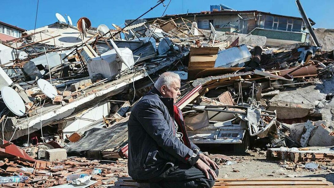 A man praying near the rubble after surviving the 7.8 magnitude earthquake in Kahramanmaras, Turkey