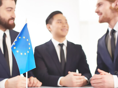 On the table, countries' flags stand as symbols of international cooperation, adding a dynamic visual element to the strategic conversations taking place among the individuals