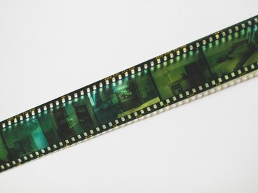 A lone film negative resting against a clean backdrop, reflecting the importance of preserving Argentina's audiovisual legacy before it fades away
