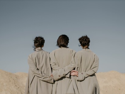 Three people wearing the same coat